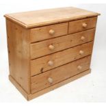 A pitch pine chest fitted two short & three long graduated drawers with turned knob handles & on