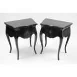 A pair of black-finish bedside tables in the continental style, each fitted frieze drawer & on