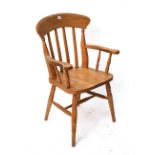 A beech lath-back carver chair with hard seats & on ring-turned legs with turned stretchers.