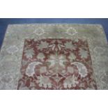 A modern carpet of ivory & crimson ground & with all-over multi-coloured floral design, 9' 10" x 12'