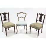 A pair of late Victorian carved rail-back occasional chairs with padded seats &on fluted round