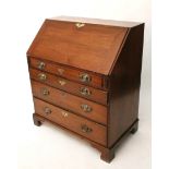 A 19th century oak bureau with fitted interior enclosed by fall-front above four long graduated