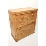 A pine chest fitted two short & three long graduated drawers with turned knob handles, & on plinth