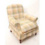 A modern armchair upholstered multi-coloured chequered material, & on short turned legs.