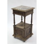 A late 19th/early 20th century continental oak marble-top upright two tier cabinet, fitted frieze