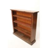 A 19th century oak small standing open bookcase with three adjustable shelves, & on plinth base, 42”