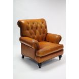 A MODERN TAN LEATHER BUTTONED-BACK ARMCHAIR, on turned feet.