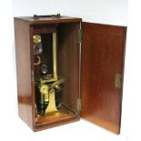 A LATE 19th/EARLY 20th CENTURY BRASS MONOCULAR MICROSCOPE BY BAKERS OF LONDON, with three additional