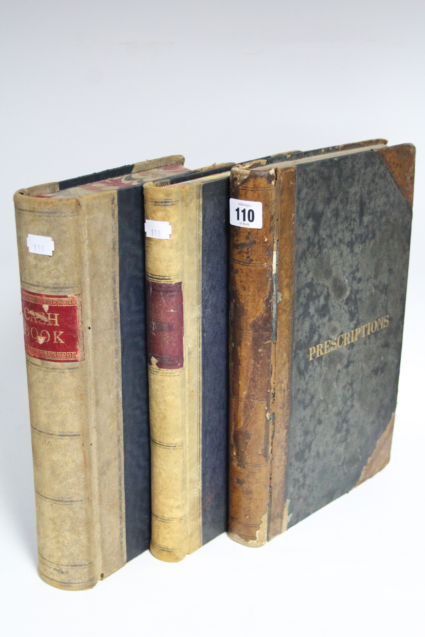 A late 19th century leather-bound “Prescriptions” book; & two early 20th century leather-bound