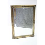 A large gilt frame rectangular wall mirror with raised scroll border & inset bevelled plate, 41” x