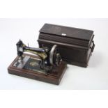 A Singer hand sewing machine with walnut case.