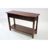 A mahogany-finish side table fitted two frieze drawers & on square legs with open undertier, 47¼”