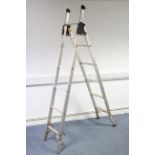 A Youngmans aluminium 3-waqy combination ladder; & a wheelbarrow.