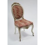 A 19th century painted & floral-carved occasional chair with oval padded back & shaped seat, on