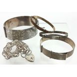 A part-engraved still hinged bangle, Chester 1961; two smaller silver stiff bangles; a plated ditto;