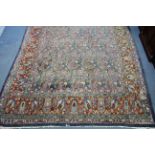 A Persian carpet with all-over multi-coloured paisley design within wide borders; 12'8" x 9'8".