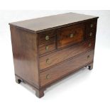 An early 19th century mahogany chest fitted an arrangement of six various drawers with brass round