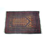 A Persian prayer rug with orange ground centre & repeating stylised floral motifs within crimson