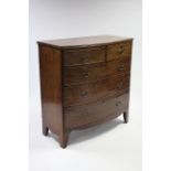 An early 19th century mahogany bow-front chest fitted two short & three long graduated drawers