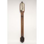 A Victorian walnut stick barometer with rounded top, the ivory calibrated dial with vernier,