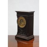 An Ansonia mantel clock with 5" diam. gilt two-part dial, in carved mahogany case; 12" high.