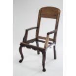 An 18th century armchair frame on mahogany cabriole legs with carved lion-paw feet & with waved