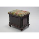 A Victorian mahogany music seat with panelled sides & barley-twist corner columns, the hinged padded