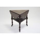 A late Victorian triangular occasional table with three drop leaves forming a circular top when