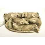 A JAPANESE IVORY OKIMONO carved in the form of a family of eleven rats huddled inside an oyster