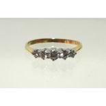 An 18ct. yellow gold & platinum ring set row of five small graduated diamonds; size P/Q.