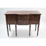 A regency mahogany small bow-front sideboard fitted central frieze drawer above an apron drawer, a