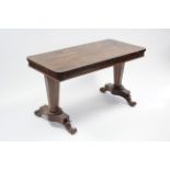 An early Victorian rosewood centre table, the rectangular top on two octagonal tapered end columns