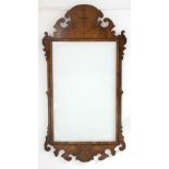 An 18th century style rectangular wall mirror in burr-elm veneered frame with fret carved scroll