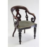 A mid-Victorian mahogany elbow chair with scroll arms & pierced splat to the rounded open back,