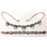 A silver leaf-design necklace set five graduated synthetic aquamarines; & similar bracelet also