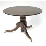 A Regency mahogany breakfast table, the circular figured tilt-top on turned baluster centre column &