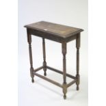 A mahogany rectangular occasional table on turned & fluted legs with plain stretchers, 24¾” wide.