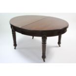 A LATE 19th CENTURY MAHOGANY EXTENDING DINING TABLE, with oval top, two additional leaves, wine-