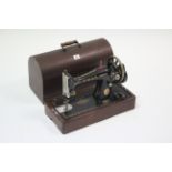 A Singer hand sewing machine with carrying case.