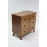 A small oak-finish chest fitted three long drawers with turned knob handles, & on bracket feet, 29¾”