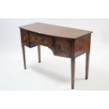 An early 20th century mahogany crossbanded bow-front kneehole dressing table fitted three frieze