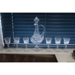 A heavy cut-glass ovoid decanter with loop handle, finial stopper & on round pedestal foot, 16¾”