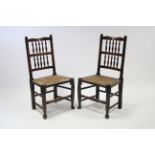 A pair of Lancashire-style spindle-back cottage dining chairs with woven rush seats, & on turned