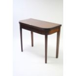 A 19th century mahogany tea table with rounded corners & moulded edge to the rectangular fold-over