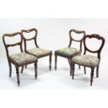 A pair of Victorian mahogany dining chairs with open kidney-shaped backs, padded drop-in seats, &