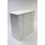 A late Victorian white painted pine chest fitted two short & three long graduated drawers with