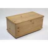 A pine blanket box with hinged lift-lid & on steel castors, 35” wide