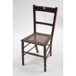 A late Victorian walnut rail-back occasional chair with woven-cane seat & on ring-turned tapered