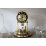 A 1950’s 400-day mantel clock under glass domed dust shade; together with a set of twelve glass