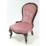 A Victorian beech-frame spoon-back nursing chair with buttoned back & sprung seat upholstered pink